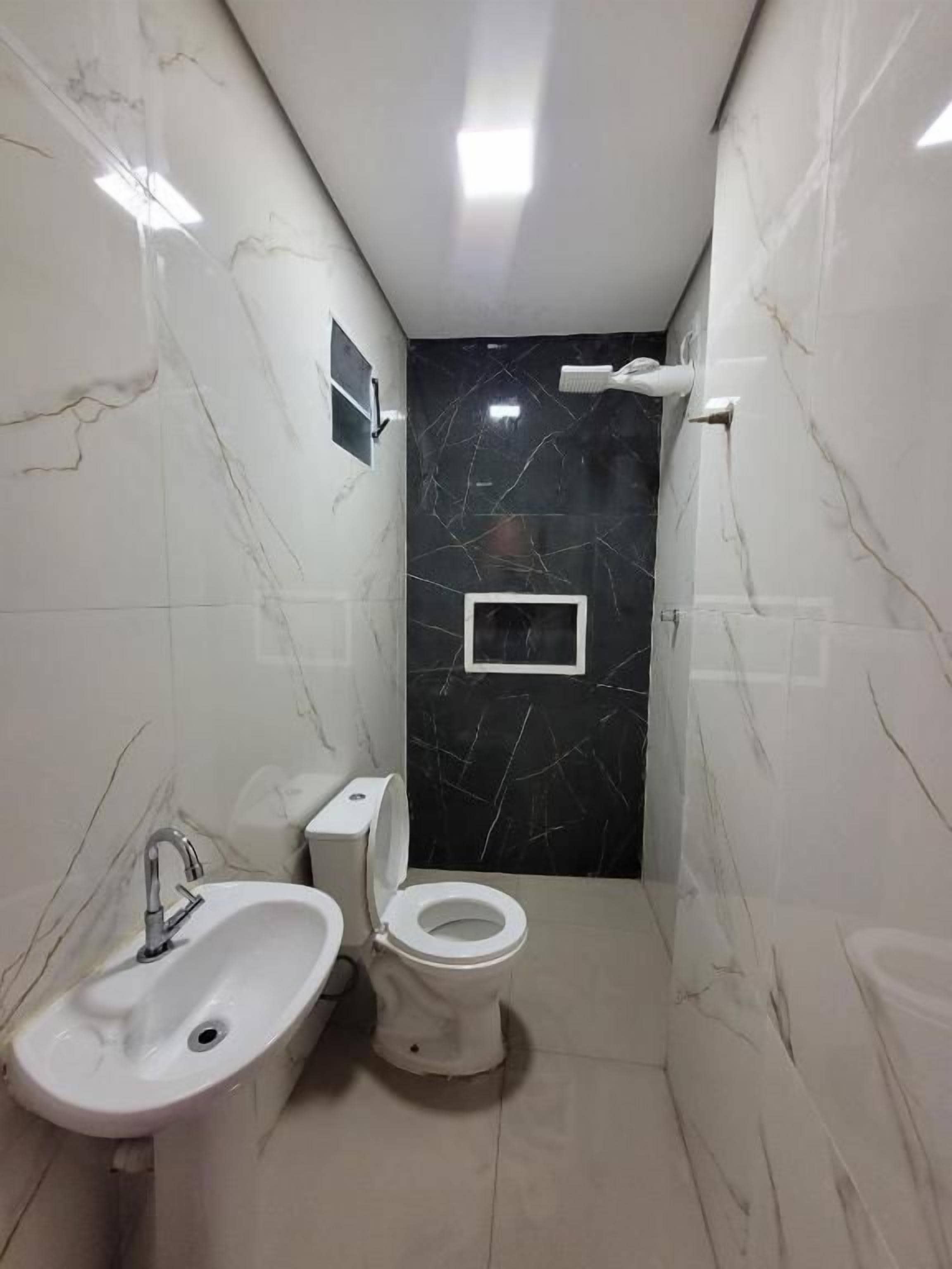 A bathroom with a sink, toilet, and shower.