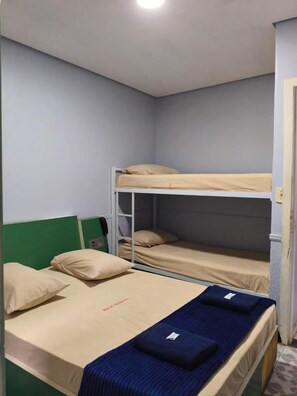 A bunk bed room with a single bed and a bunk bed.