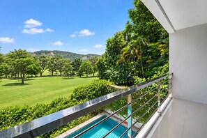 A balcony with a view of a swimming pool and a golf course. - 4 bedroom & bathroom pool villa, with golf view. Only 7km to Patong (Tambon Kathu)