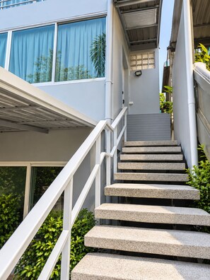 A set of concrete stairs leading up to a building entrance with a white railing. - 4 bedroom & bathroom pool villa, with golf view. Only 7km to Patong (Tambon Kathu)