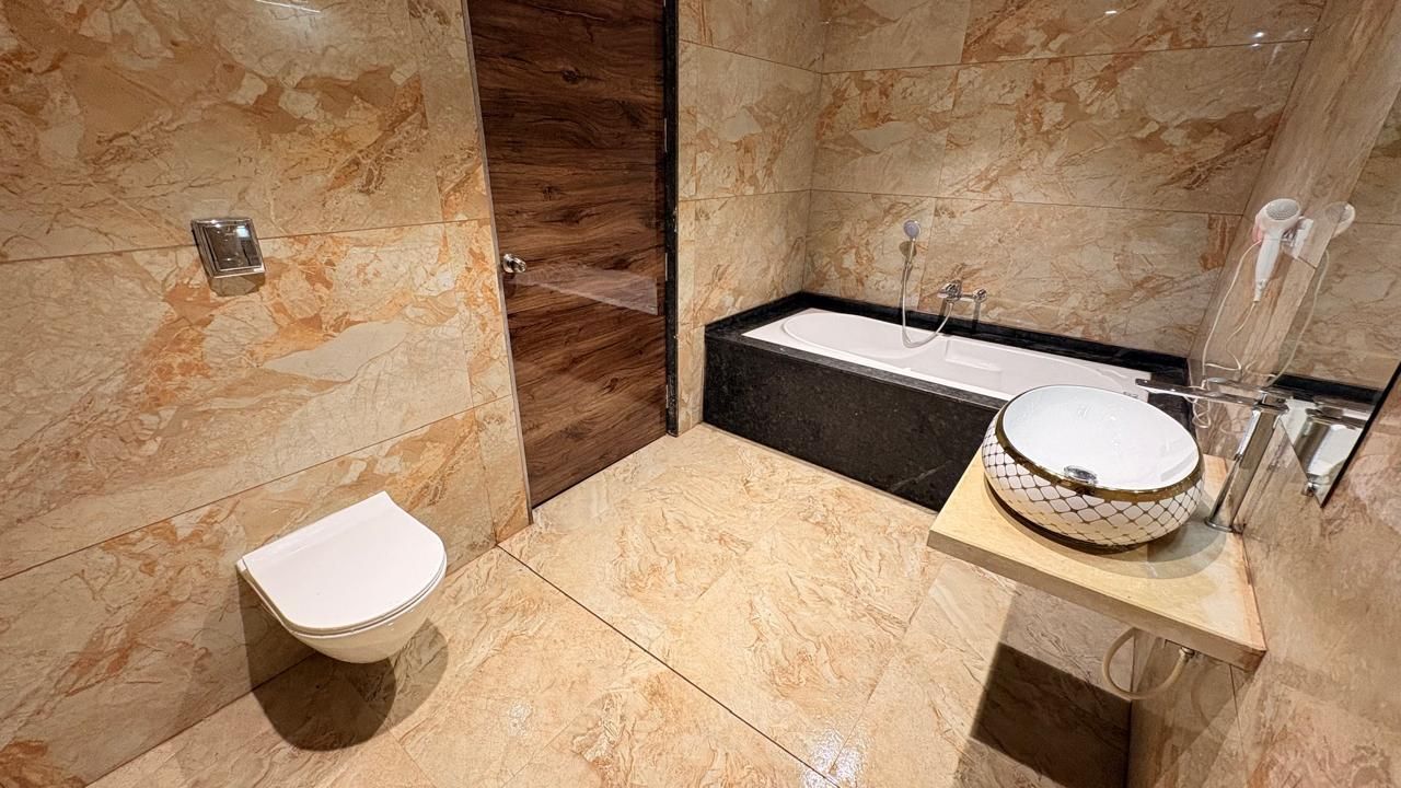 A bathroom with a toilet, a bathtub, and a sink.