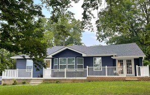 A two-story house with a front porch and a fenced yard. - Mia's House (Radcliff)