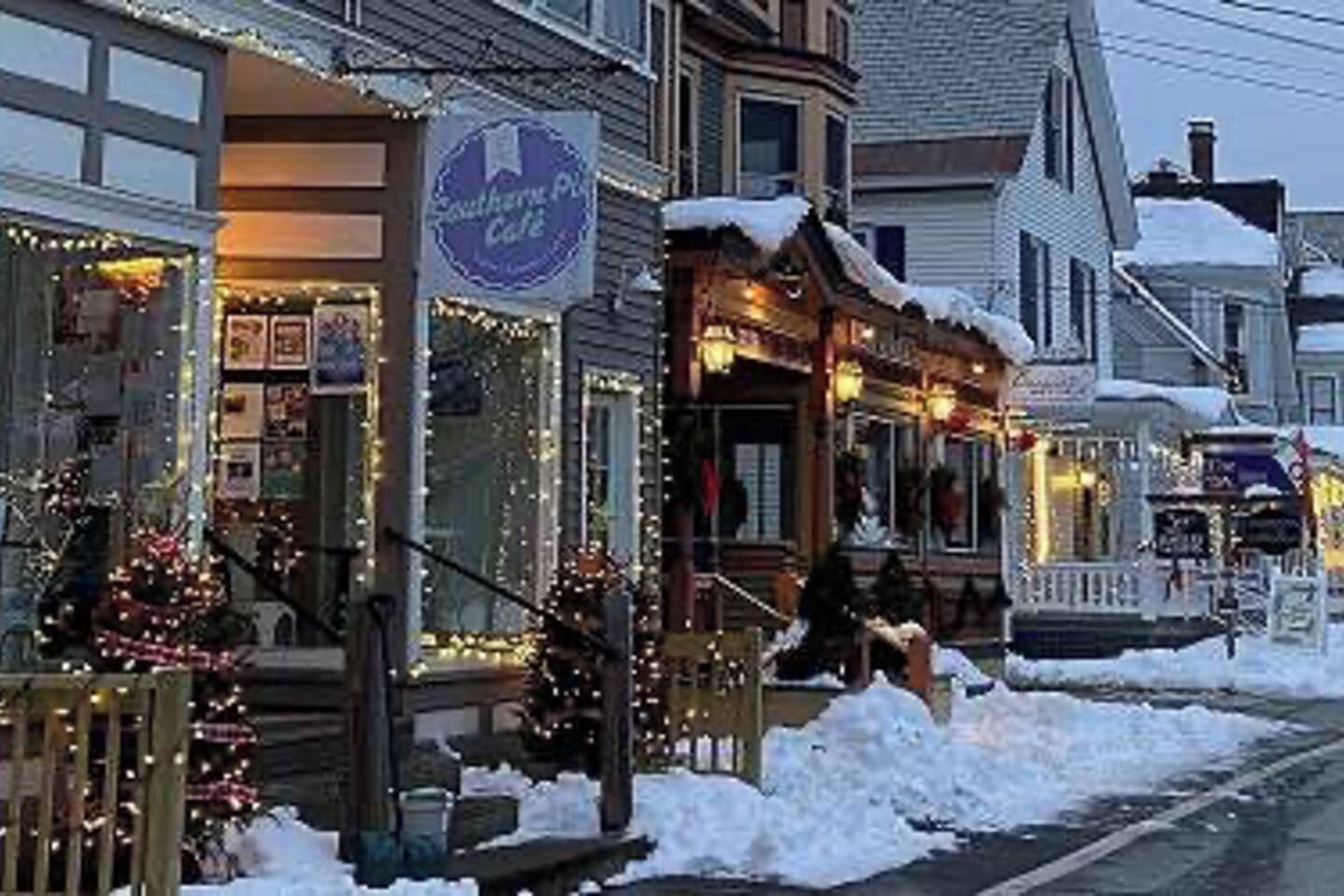 A storefront with a sign that reads 'Southern Pub Cafe' and a Christmas tree outside.