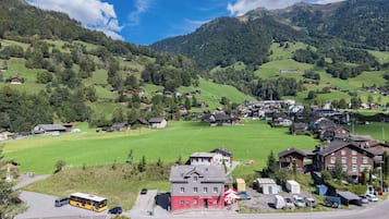 A rural village with houses, a bus station, and a road.