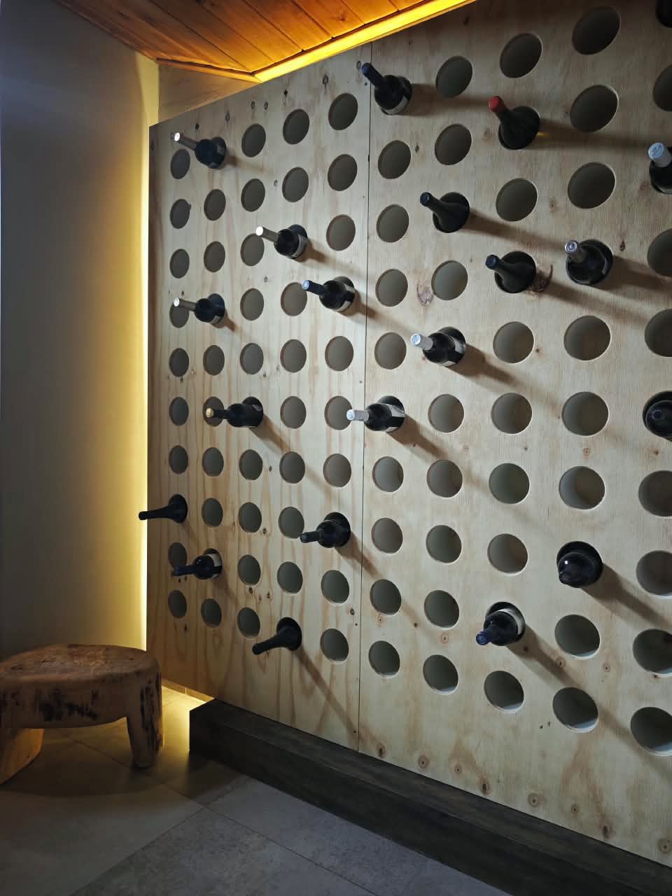 A wall with multiple wine bottle holders.