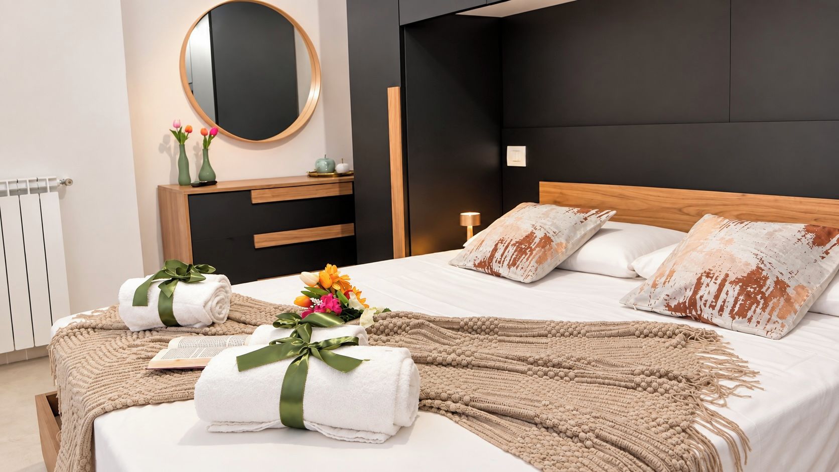 A modern bedroom with a bed, bedside tables, a mirror, and a nightstand.
