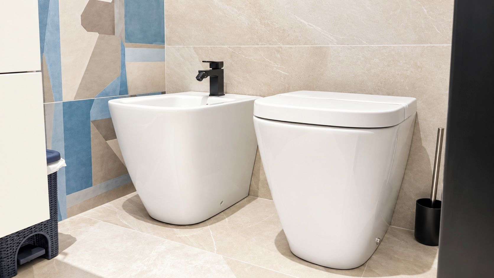 A modern bathroom with two white toilets, a black faucet, and a trash bin.