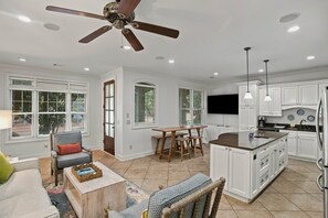 A spacious kitchen with white cabinetry, a central island, and a ceiling fan. - War Eagle Manor:Your Auburn Getaway (Auburn)