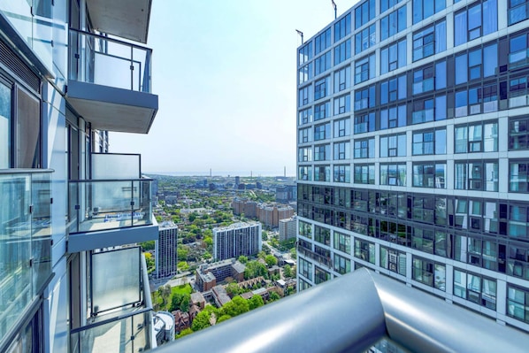 A high-rise building with a glass facade, offering expansive views of a cityscape.