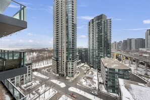 A high-rise building complex with multiple floors, a parking area, and a view of the surrounding cityscape. - RivetStays | The Neptune Design Suite – 1 Bedroom + Den Condo (Toronto)