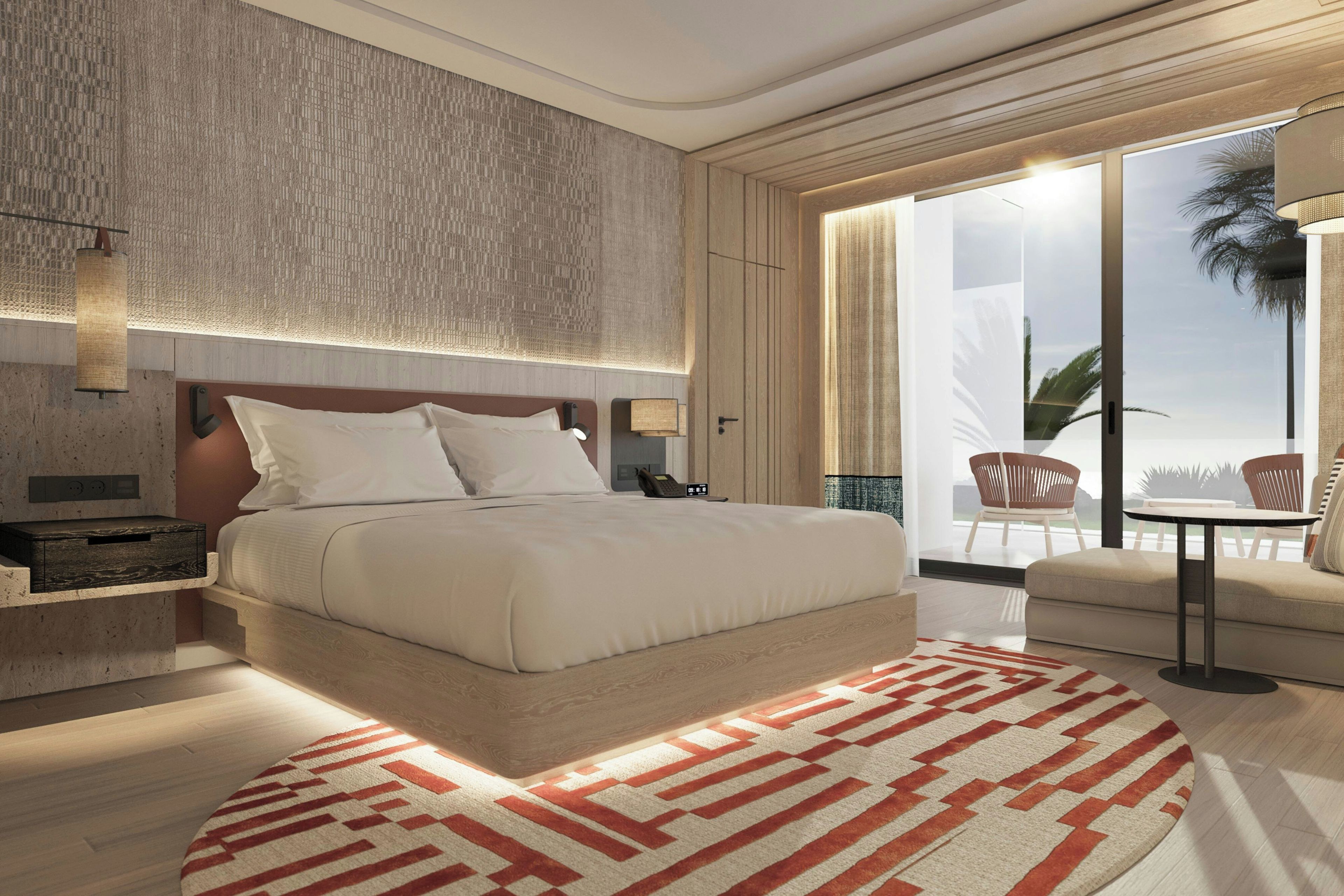A modern hotel room with a large bed, a bedside table, a nightstand, a wall-mounted lamp, and a view of the outdoors through a large window.