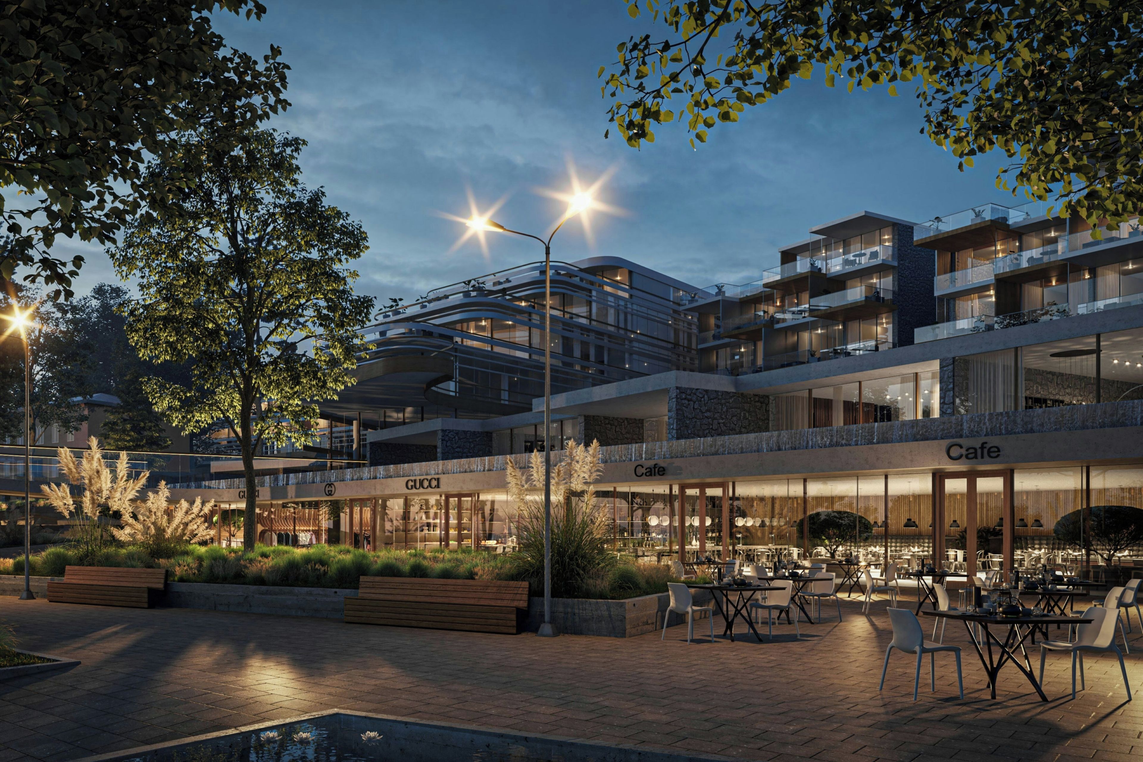 Un bâtiment moderne à plusieurs étages, doté d’un espace extérieur aménagé pour s’asseoir et d’un café.