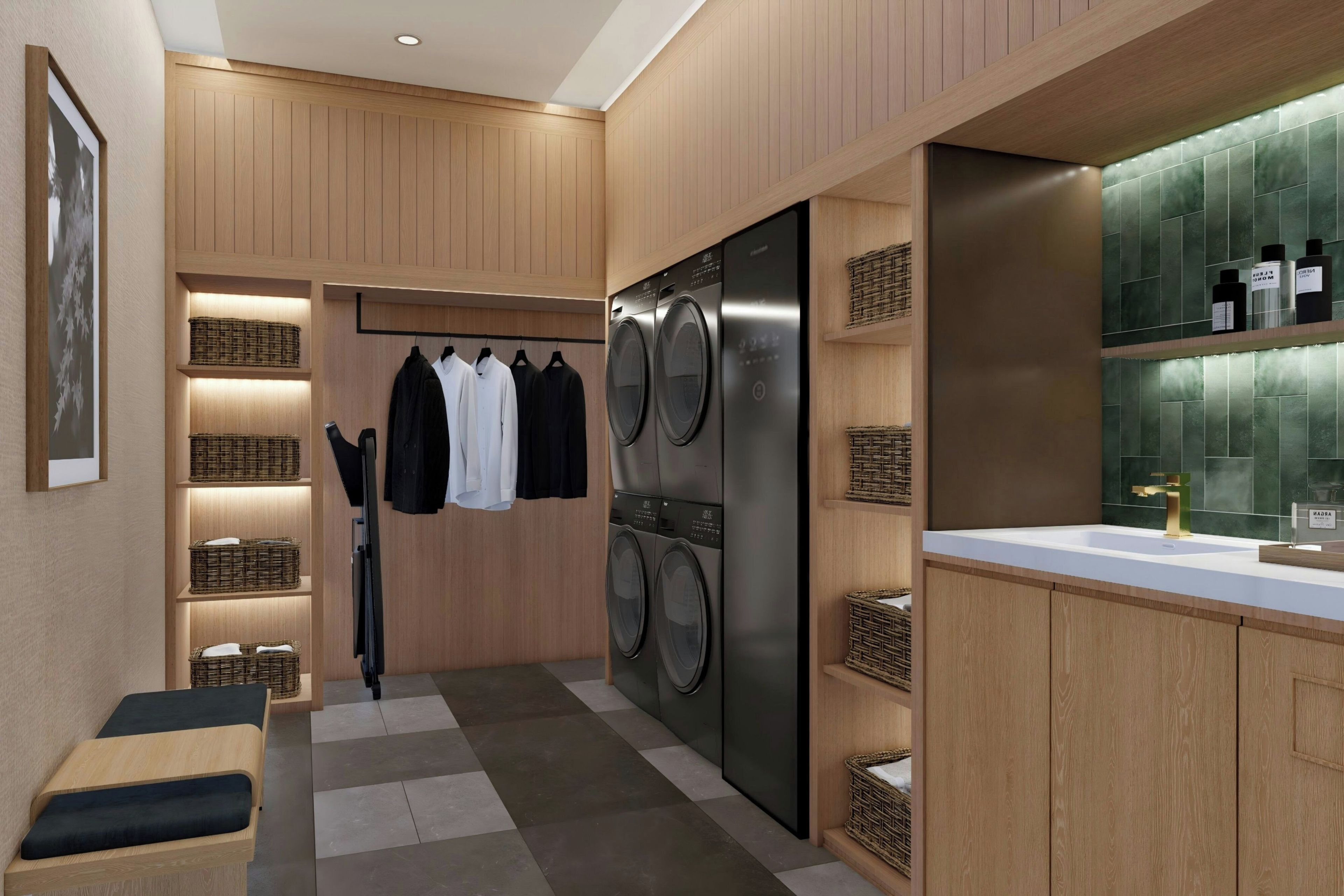 Une buanderie moderne avec un lave-linge et un sèche-linge intégrés, des armoires en bois et un petit coin salon.