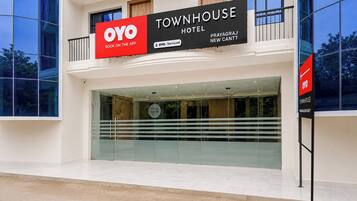 A modern building with a large sign for OYO TOWNHOUSE HOTEL.