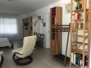 A room with a bed, a chair, a desk, a bookshelf, and a wardrobe. - Bed and Breakfast 'Le Pas Des Chevreuils' with Wi-Fi (Salles)