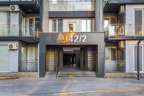 A modern building with a prominent address sign '42/2' and a logo 'ZGG'. - Apartments Zarafshan city 151 Tashkent (Tashkent)