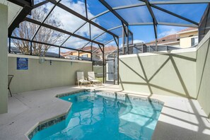 An indoor swimming pool with a glass ceiling, surrounded by lounge chairs and a poolside area. - 5BR Nemo Room Townhouse Pool, 10min Disney (Kissimmee)