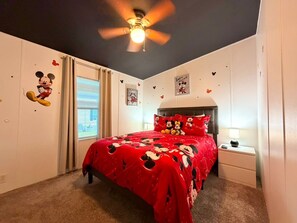 A bedroom with a bed, a nightstand, a ceiling fan, and a window with curtains. - NEW! 3bed/ 2bath house close to Disney World, The PERFECT fit! (Winter Garden)