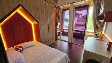 A hotel room with a bed, a wooden headboard, a bathroom, and a view of the outside.