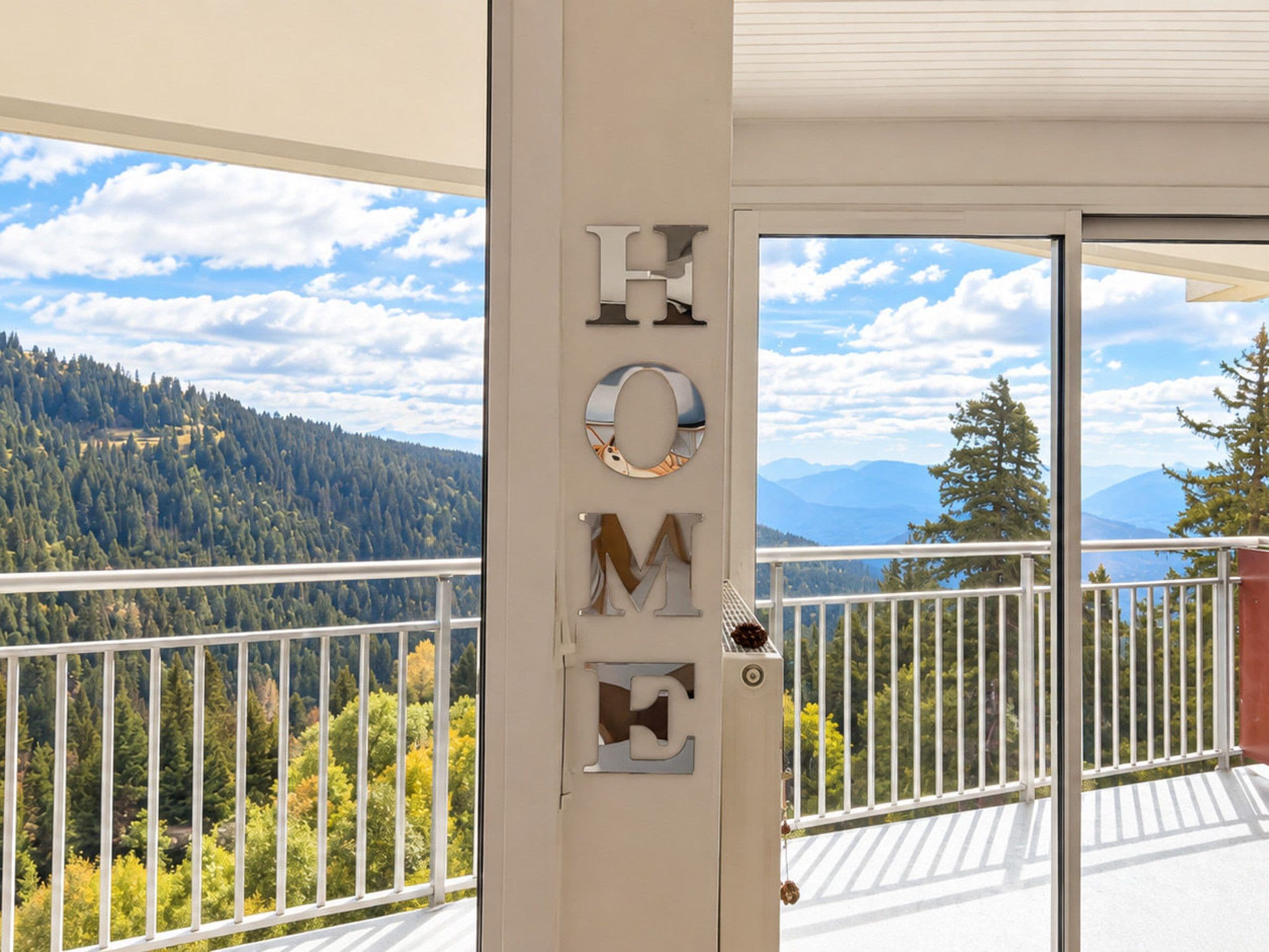 A balcony with a view of a forested mountain range.