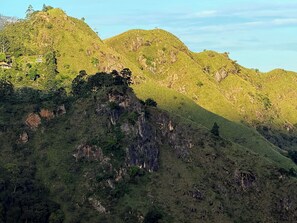 A mountainous landscape with a building labeled 'Flying Ravana' on a hill. - Peak Blooms (Ella)