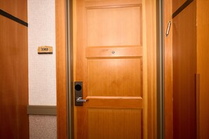 A wooden door with a number plate, a door handle, and a keyhole. - Luxury One Bedroom, Capitol Peak, Base Village steps away from lifts. (Snowmass Village)