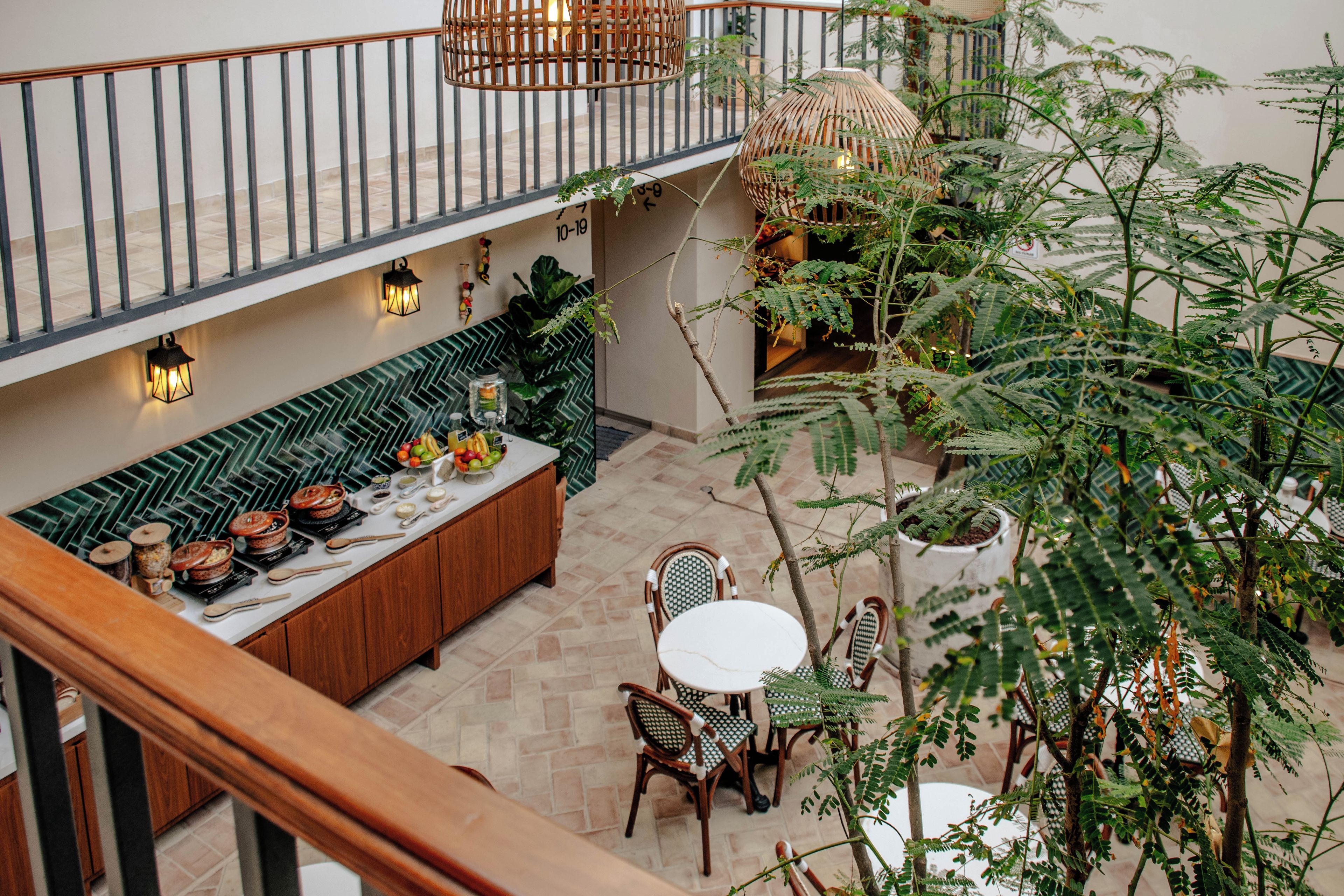 A dining area with a long wooden bench, a round table, and chairs.