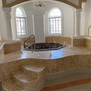 A spa area with a hot tub, steps, and large windows. - Luxurious Colonial Mansion in Puerto Plata With Private Pool (Puerto Plata)