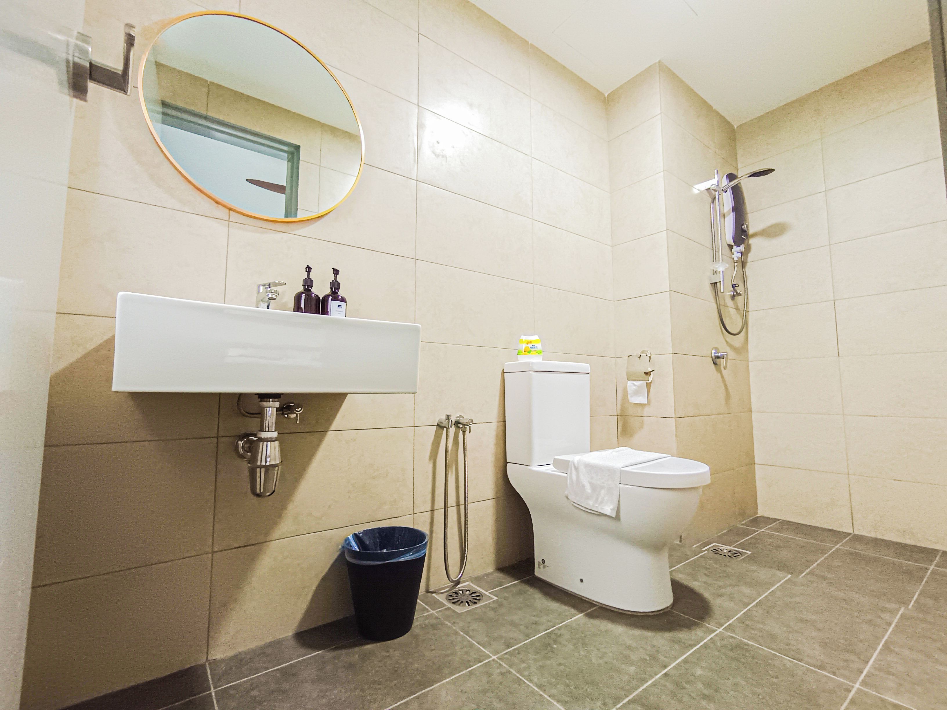 A bathroom with a sink, toilet, and shower.