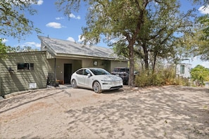 A single-story building with a car parked in front.