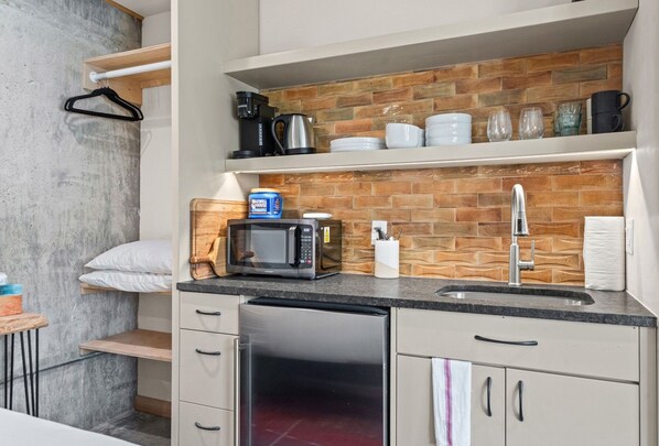 Thoughtful touches throughout, from the built-in closet with hangers to a coffee station stocked and ready to go.