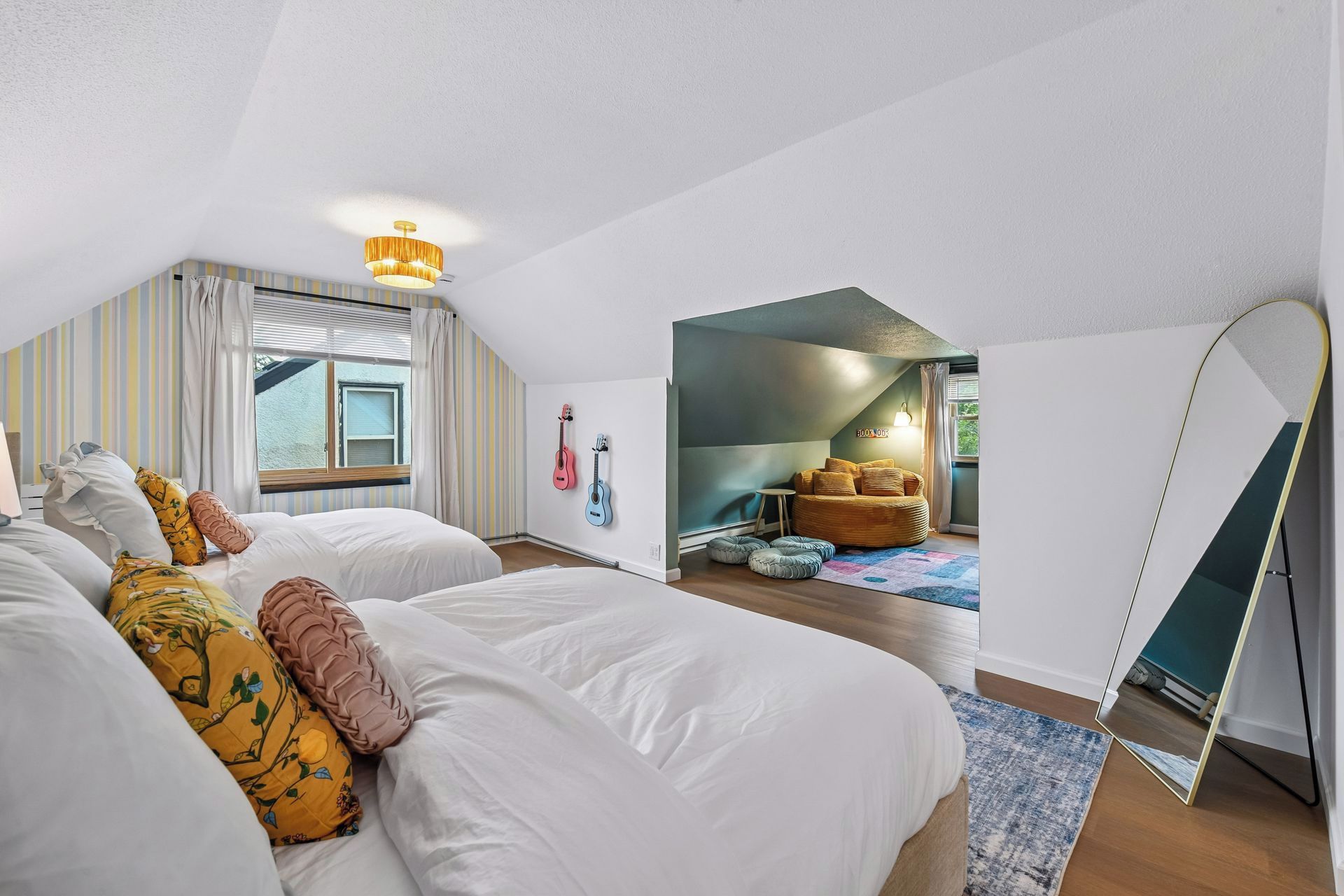 A bedroom with a large bed, a mirror, and a view of a balcony.