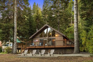 A cabin with a deck, surrounded by tall trees. - Cabin on Yakima River, Fish, Float, Golf, AC, BBQ (Cle Elum)
