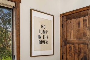 A framed sign with the text 'GO JUMP IN THE RIVER' on a wall. - Cabin on Yakima River, Fish, Float, Golf, AC, BBQ (Cle Elum)