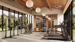 Un gimnasio moderno con equipamiento de ejercicio, grandes ventanales y vistas al exterior.
