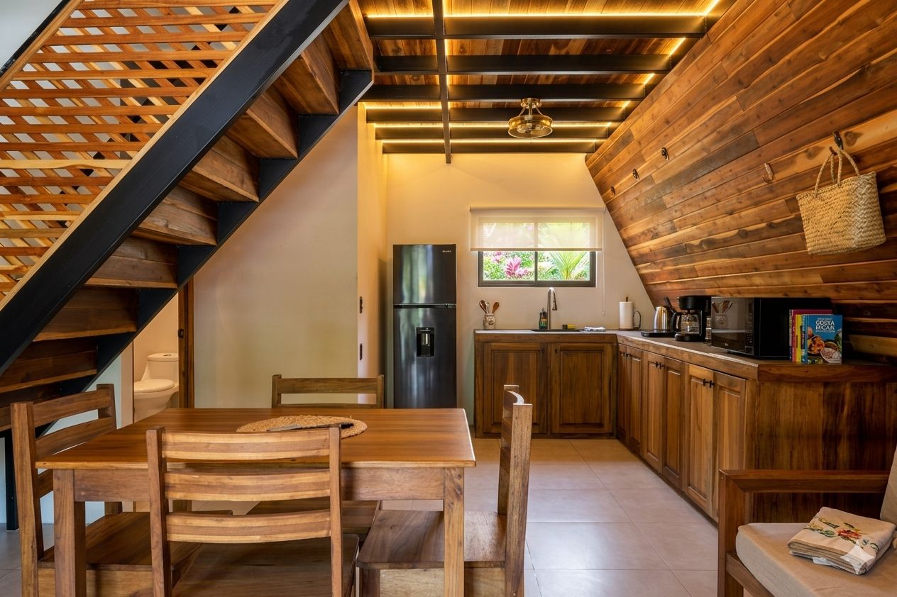 A kitchen with wooden cabinets, a refrigerator, and a window with a view of greenery.