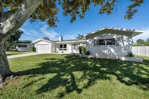 Einbungalow mit Garage, Veranda und gepflegtem Rasen.