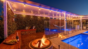 An outdoor patio with a fire pit, seating, and a pool. - Hillside Residence ~ Picturesque mountain views with four spacious bedrooms (Nowra Hill)