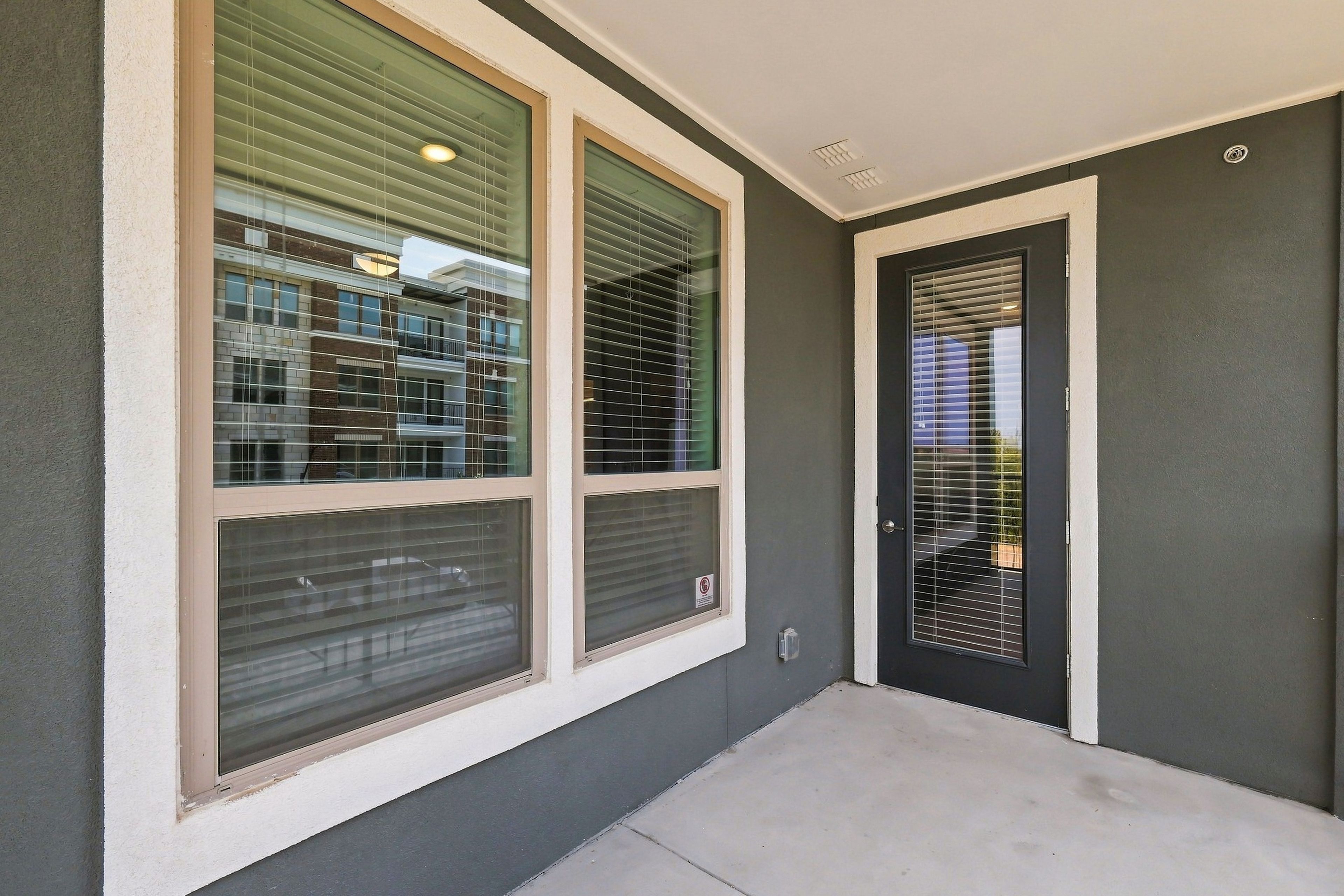 A building entrance with three large windows and a door.