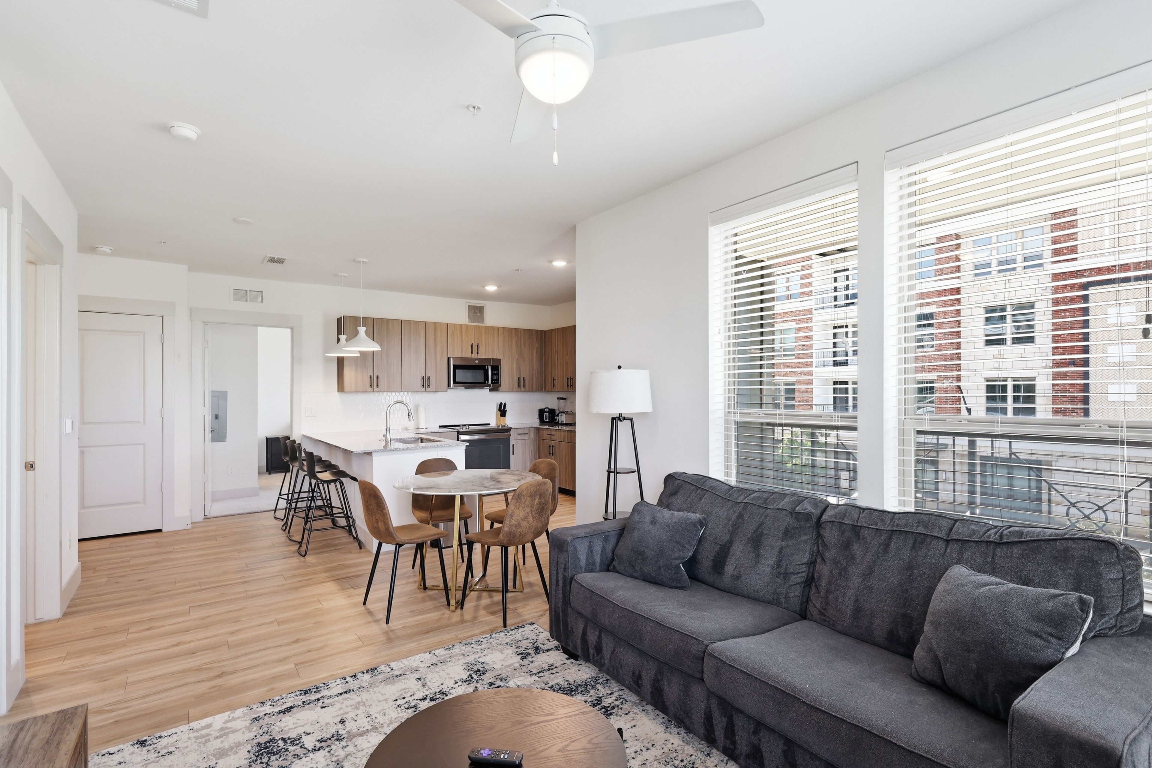 A modern apartment with a kitchen, dining area, and living room.