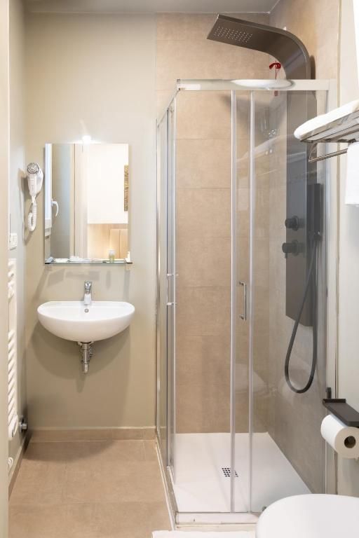 Een badkamer met een douchecabine, een wastafel en een toilet.