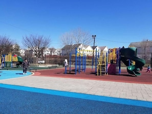 A playground with various play structures and a blue and red play area. - 8-Beds Big Stay, 10Mins NYC, Free Reserved Parking (Jersey City)