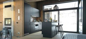 Eine moderne Küche mit Backofen, einer Kaffeemaschine und einem großen Fenster.
