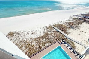 A pool area with a view of the beach and ocean. - "Broadmoor #705" --- New! Beachfront 3BR, Stunning Gulf Views, Pool, Hot Tub (Orange Beach)