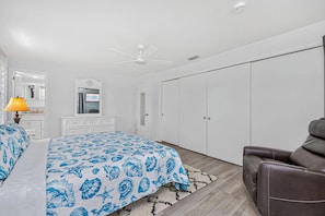 A bedroom with a bed, a desk, a wardrobe, and a chair. - Best Deal in Rotonda - Sleeps 8, Pool, Golf, Fun! (Rotonda West)