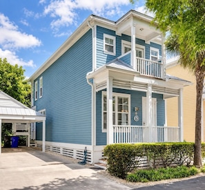 A two-story house with a porch and a garage. - Reef House Islamorada | Beach • Pool • Marina (Islamorada)