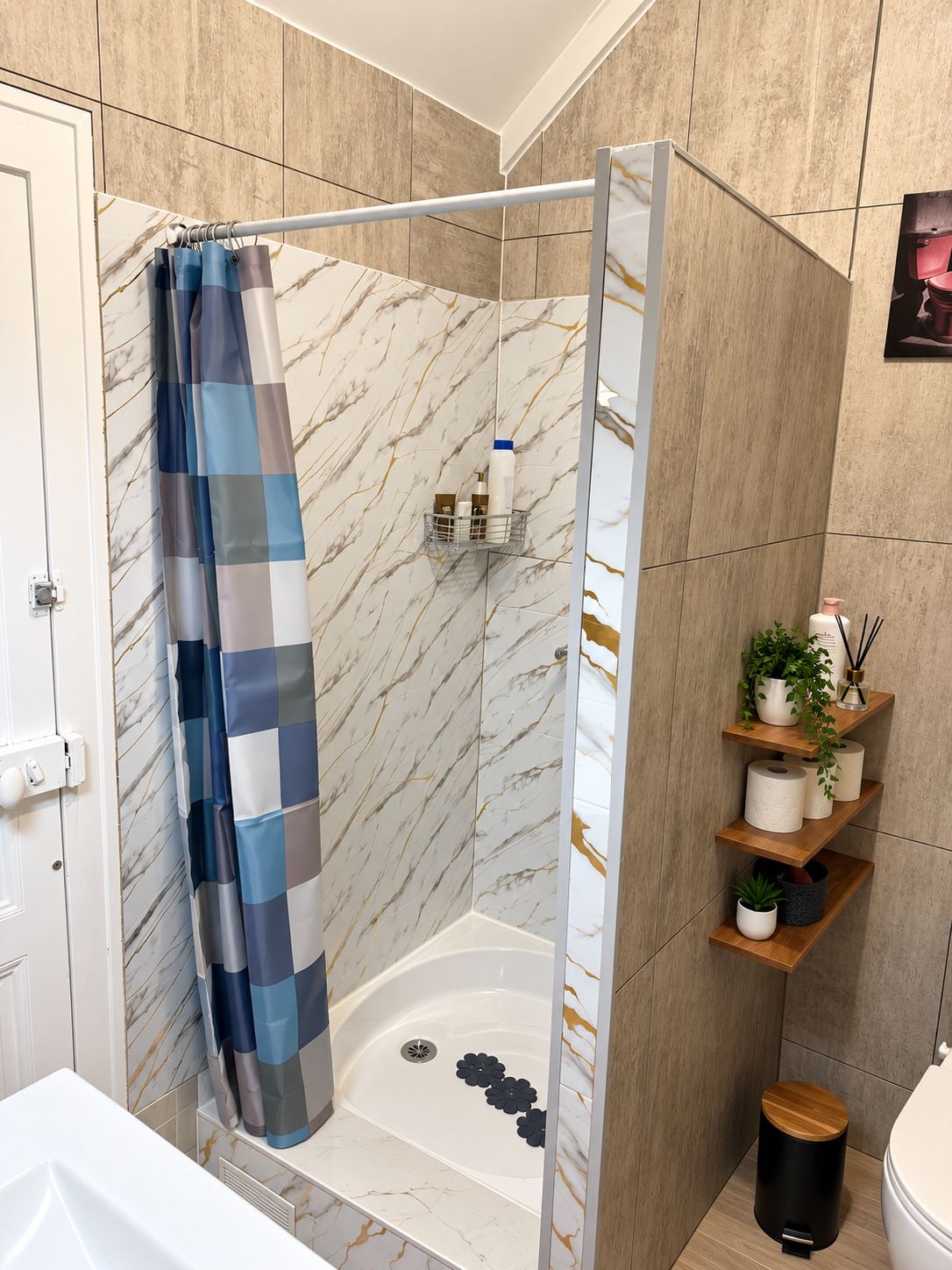 A bathroom with a shower curtain, a bathtub, and a toilet.
