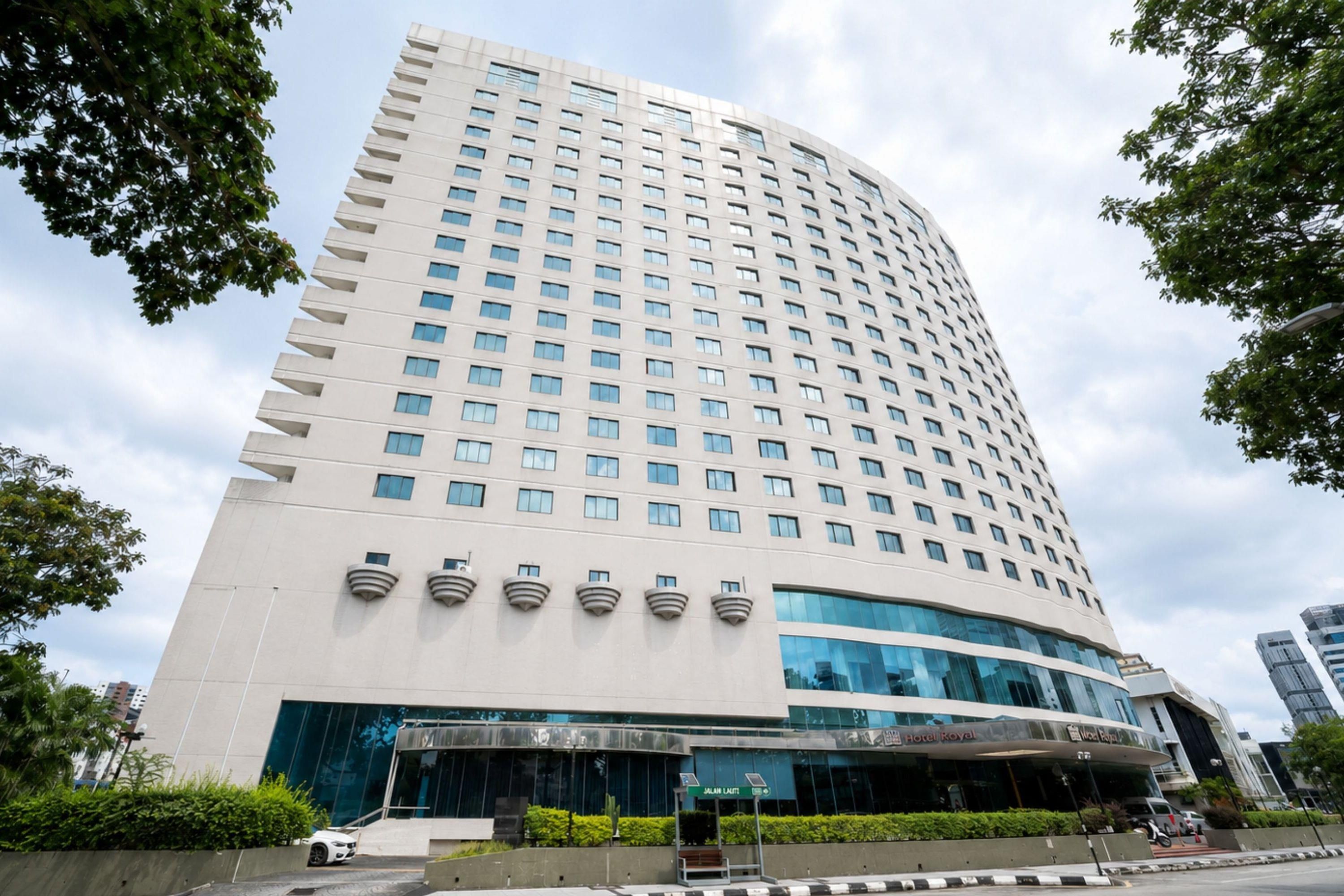 A high-rise hotel with a modern design, featuring a curved facade and numerous windows.