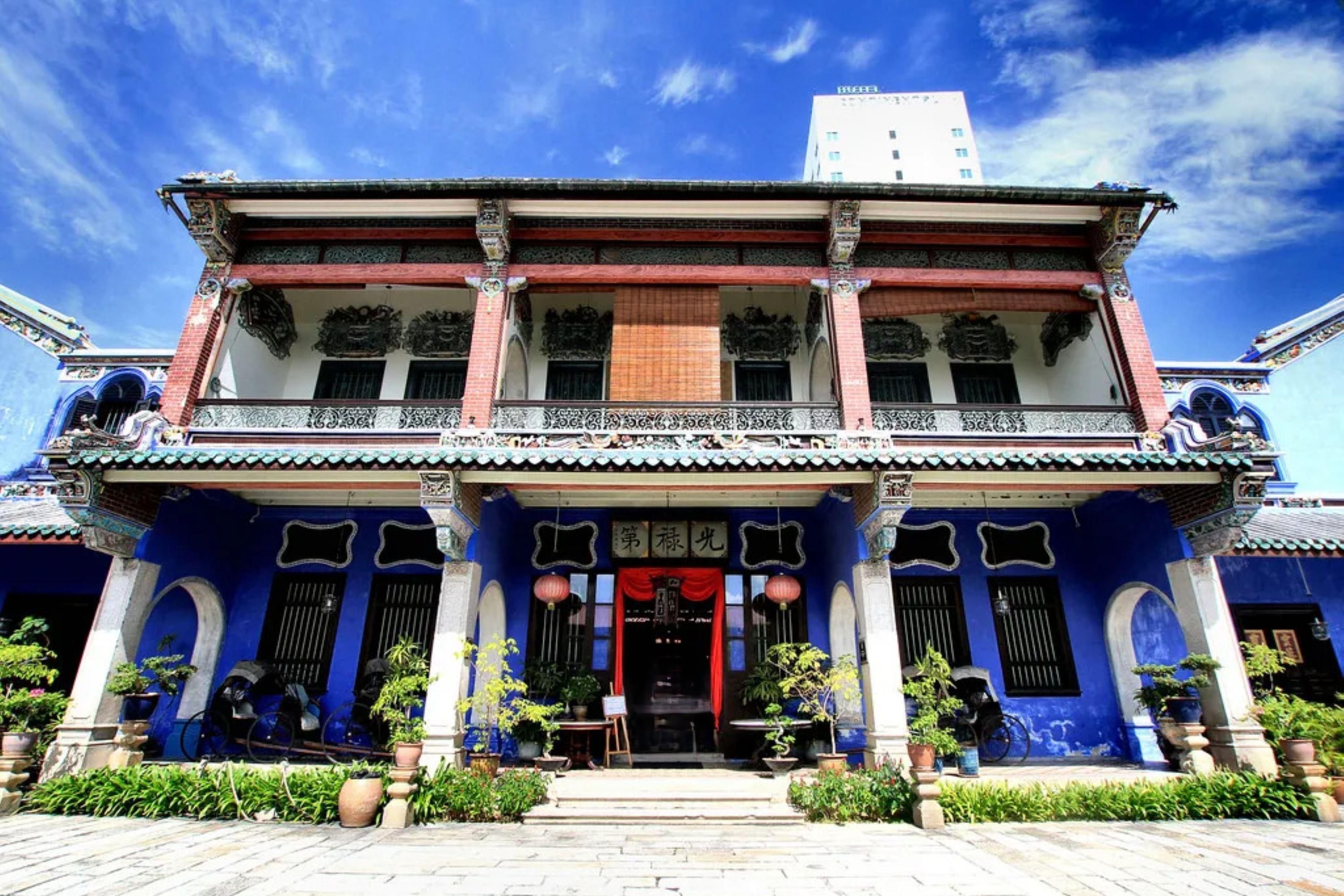 A traditional building with a two-story facade, ornate decorations, and a balcony with railings.