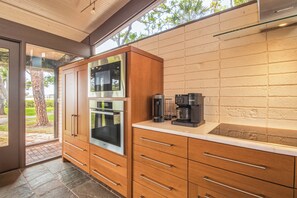 A modern kitchen with a built-in oven, microwave, and coffee maker. - Spacious 4 BR GULF Front POOL Home! Private Dock with Boat Lift! FREE Golf Cart! (Palm Harbor)